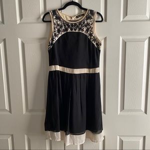 Ivory/black A-line sleeveless dress, beaded design